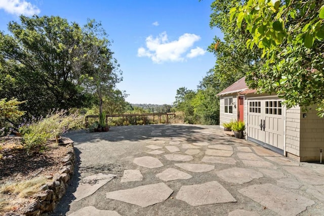 view of patio / terrace featuring an outdoor structure and a garage