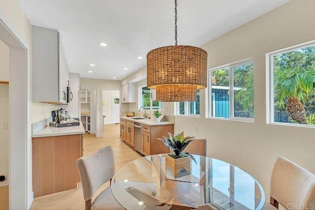 dining area featuring light hardwood / wood-style floors and sink