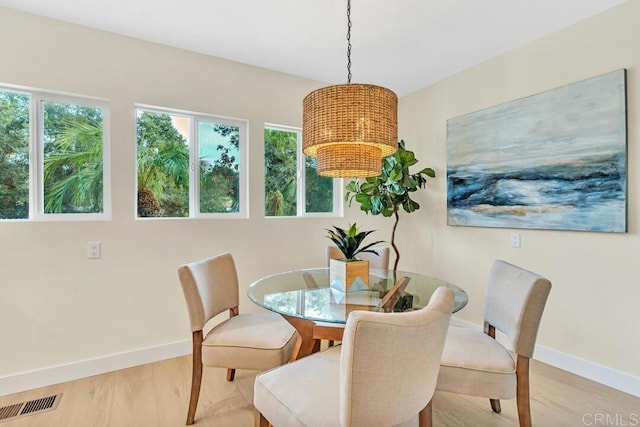 dining space featuring plenty of natural light and light hardwood / wood-style floors