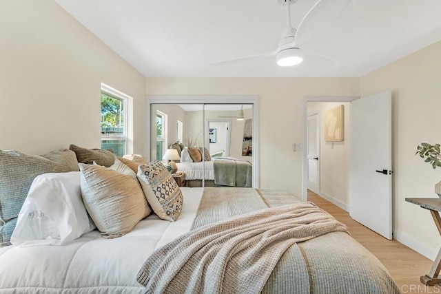 bedroom with a closet, ceiling fan, and light wood-type flooring