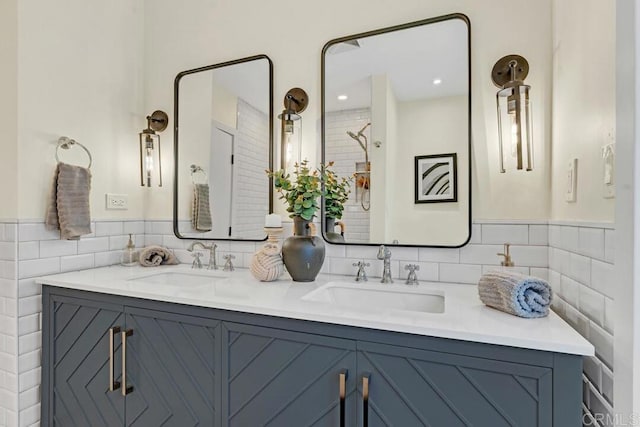 bathroom with vanity and tile walls