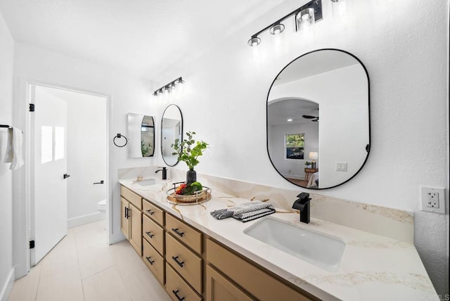 bathroom featuring toilet, vanity, and tile patterned flooring