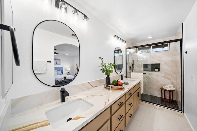 bathroom featuring vanity and an enclosed shower