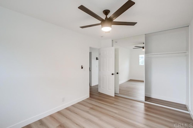 unfurnished bedroom with light wood-type flooring, a closet, and ceiling fan