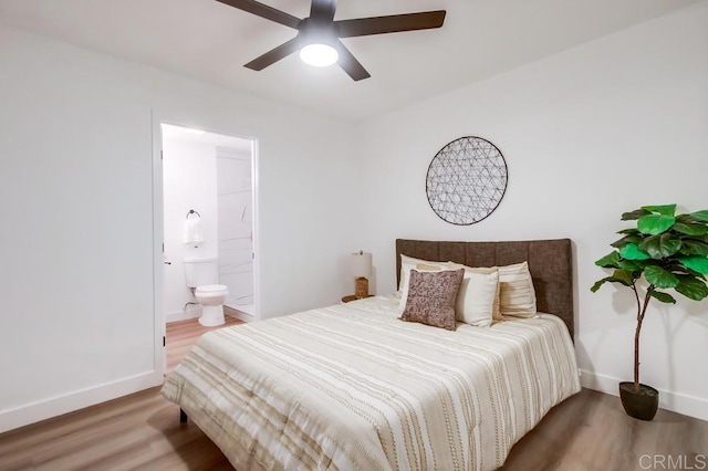 bedroom featuring ensuite bath, ceiling fan, and hardwood / wood-style flooring