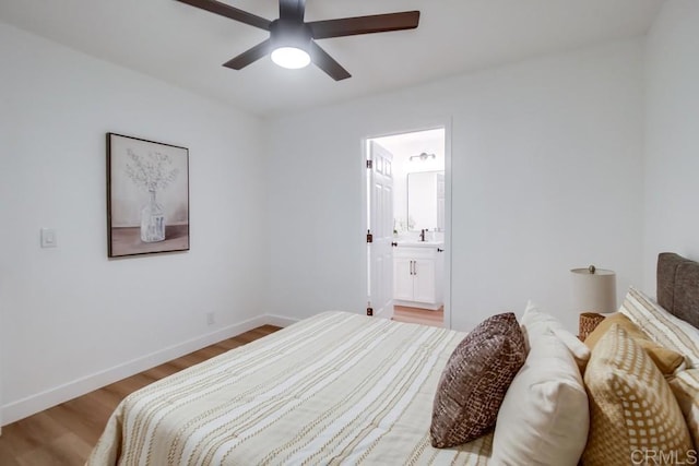 bedroom with ceiling fan, ensuite bathroom, and light hardwood / wood-style floors