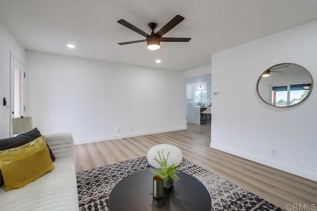 living room featuring ceiling fan and wood-type flooring