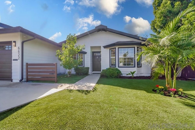 view of front of property featuring a front lawn and a garage