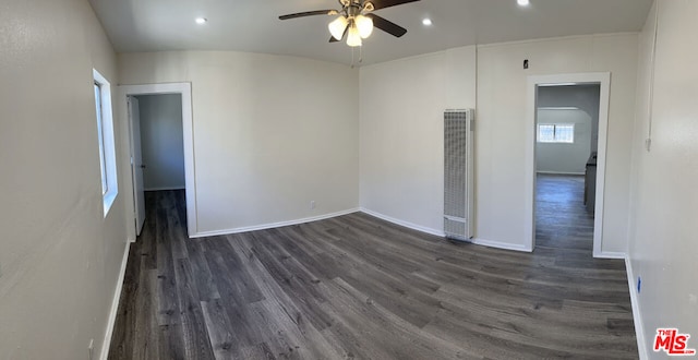 empty room featuring dark wood-type flooring and ceiling fan