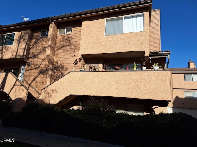 back of house with a balcony