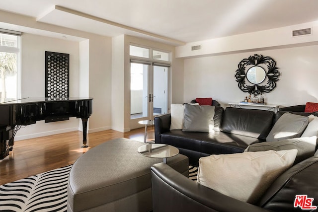 living room with wood-type flooring and french doors