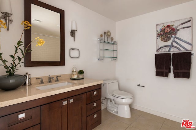 bathroom featuring toilet, a shower with shower curtain, tile patterned flooring, and vanity