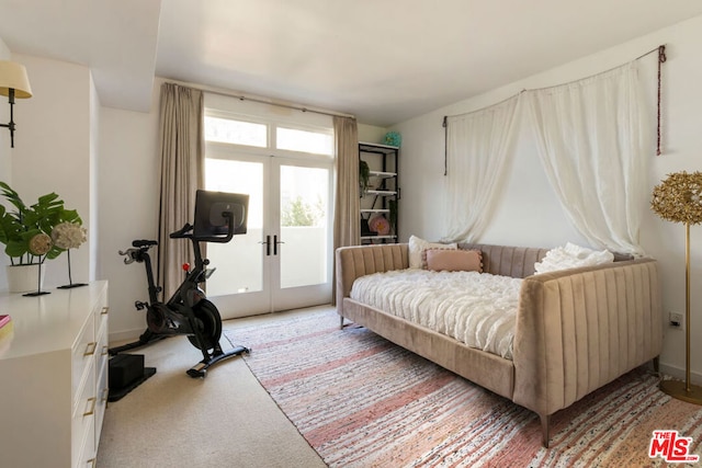 sitting room featuring carpet floors and french doors