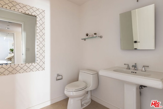 bathroom featuring toilet and tile patterned floors