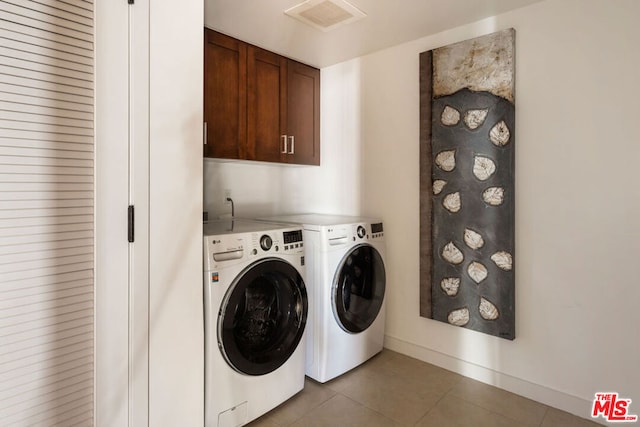 washroom with separate washer and dryer and light tile patterned floors