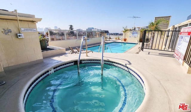 view of pool featuring a hot tub