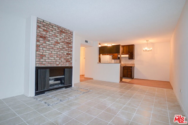 unfurnished living room with light tile patterned floors and an inviting chandelier