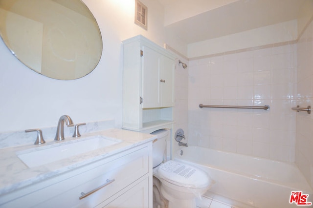 full bathroom featuring toilet, tiled shower / bath combo, and vanity