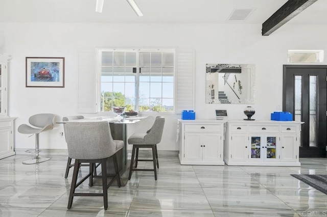 dining room with beamed ceiling