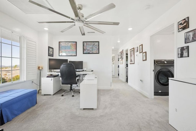 carpeted home office featuring washer / dryer and ceiling fan