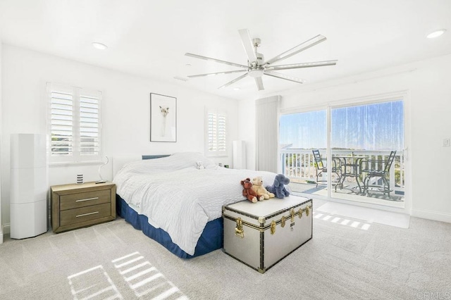 carpeted bedroom with ceiling fan and access to outside