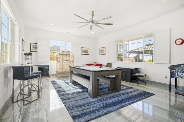 rec room with ceiling fan and plenty of natural light