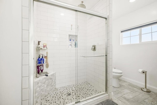 bathroom featuring toilet and walk in shower