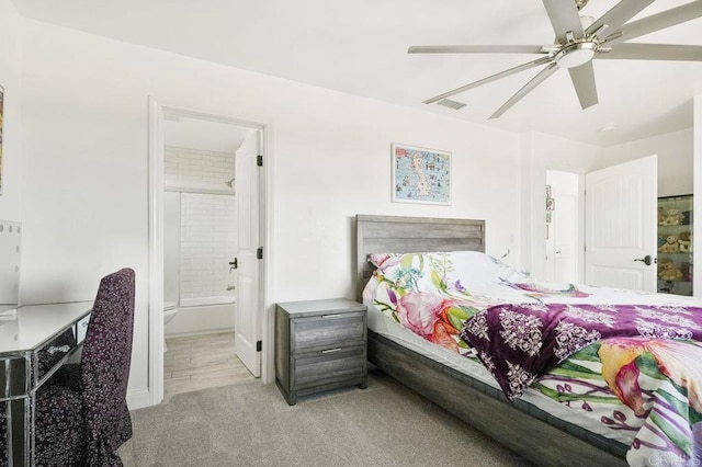 carpeted bedroom featuring ensuite bathroom and ceiling fan