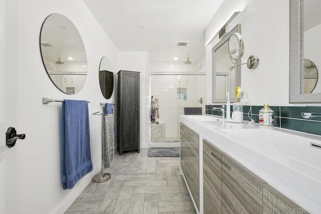 bathroom with vanity, parquet floors, and an enclosed shower