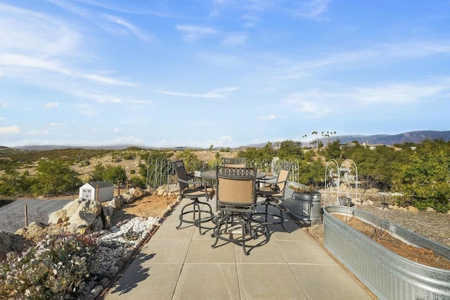 view of patio / terrace featuring a mountain view