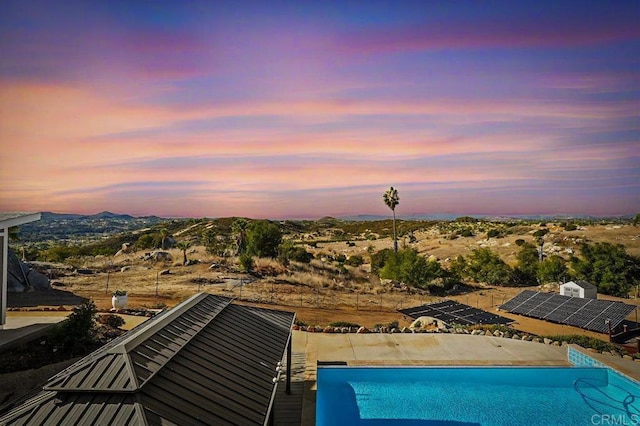 view of pool at dusk