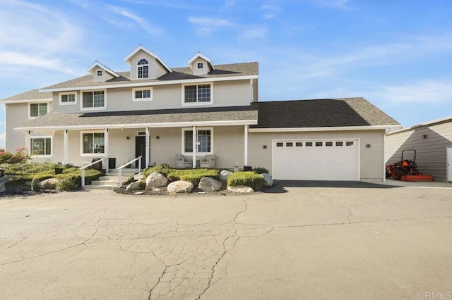 view of front of house with a garage and covered porch