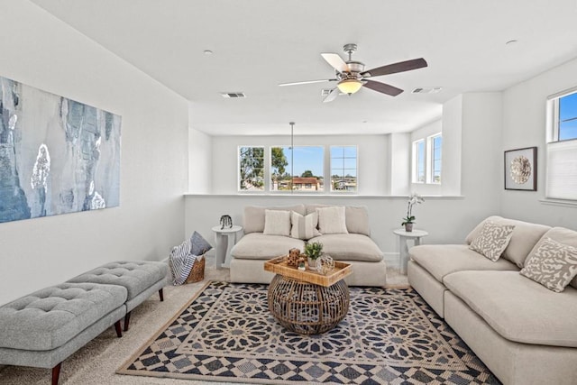 carpeted living room featuring ceiling fan