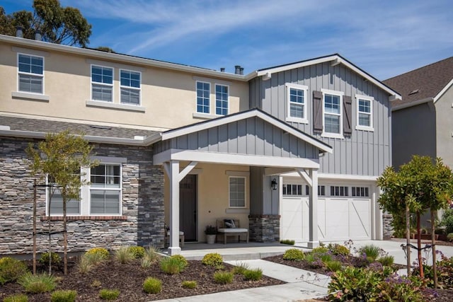 view of front of house featuring a porch and a garage