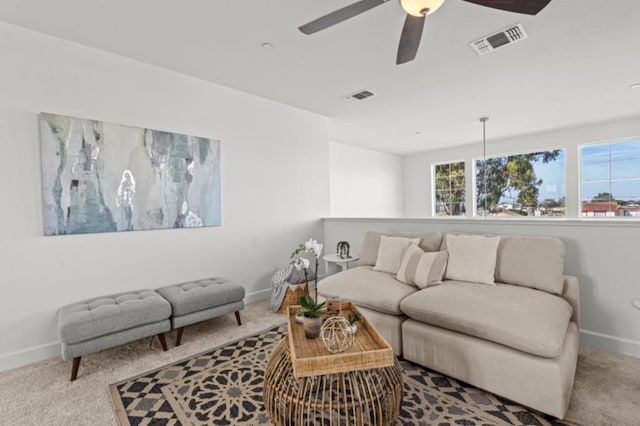 living room with ceiling fan and light colored carpet