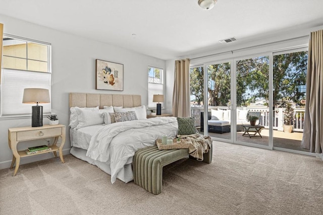 bedroom with access to exterior and carpet flooring