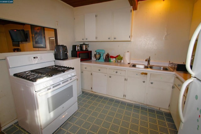 kitchen with sink, white appliances, and white cabinets