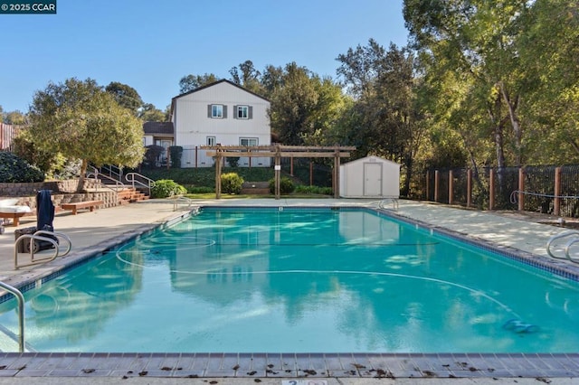 view of swimming pool featuring a patio, a storage unit, and a pergola