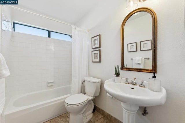 bathroom featuring toilet, shower / tub combo, and tile patterned floors