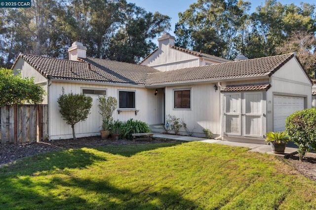 view of front of property with a front yard and a garage