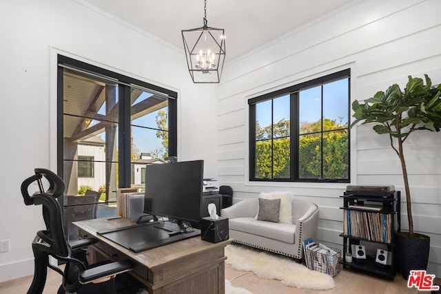 office area with ornamental molding, light hardwood / wood-style flooring, and a notable chandelier