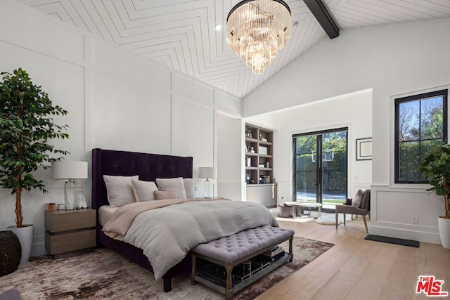 bedroom with high vaulted ceiling, beamed ceiling, an inviting chandelier, and hardwood / wood-style floors