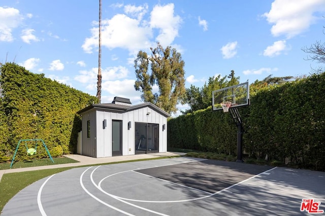 view of basketball court featuring a playground