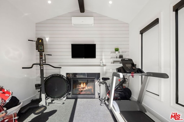 workout room with an AC wall unit, wood walls, and vaulted ceiling