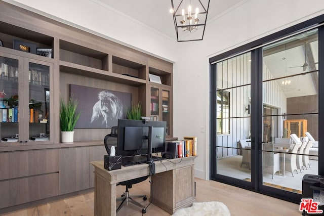 office with light wood-type flooring, a chandelier, and crown molding