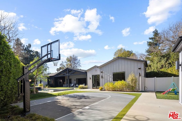 view of basketball court with a pool