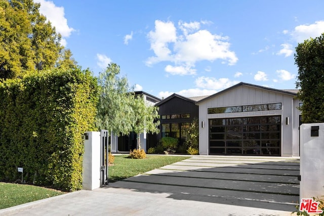 view of front of home featuring a garage and a front lawn