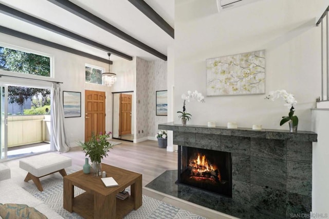 living room with a multi sided fireplace, beam ceiling, and wood-type flooring