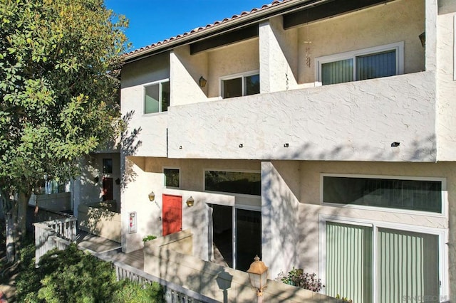 back of property featuring a balcony