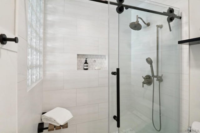 bathroom featuring a shower with shower door